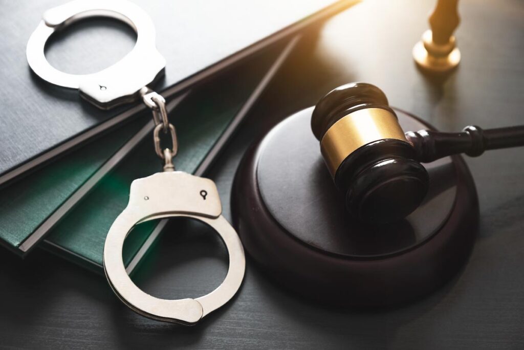 Handcuffs and wooden gavel
