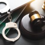 The Role of a Criminal Defense Attorney | Schaffer Kennedy Johnson Handcuffs and wooden gavel