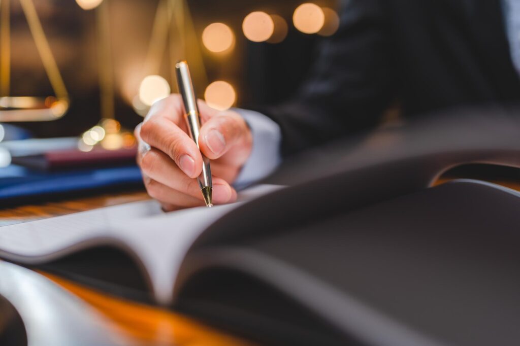 businessmen's hand putting signing contract or agreement form, Lawyers or attorneys