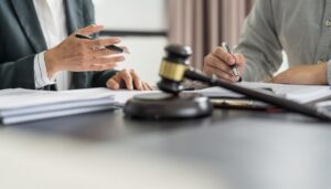 Lawyer Legal counsel presents to the client a signed contract with gavel and legal law. justice and lawyer Business partnership meeting concept.